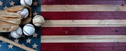Old baseballs, bat and glove on Wood United States flag background. Baseball sports concept with copy space