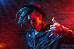 Portrait of a crazy disco man with dreadlocks. Party, disco. Colorful light.