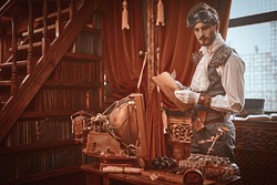 Scientist steampunk man inventor works in his laboratory with Victorian interior. Adventure world of steampunk.