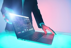 Modern business technologies. The hands of a male business analyst demonstrate indicators reflecting business dynamics on a laptop.