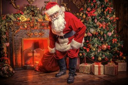 Santa Claus bring the sack with gifts for Christmas. The house is beautifully decorated for Christmas.
