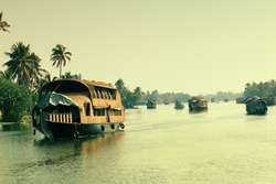 Picturesque tropical landscape with traditional houseboat.