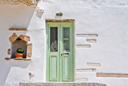 Traditional door and wall in white cycladic architecture