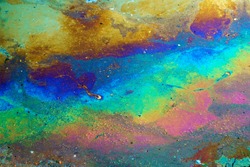 abstract texture of colorful rainbow oil slick background, chemical oil fuel splitting and splashing on the water surface