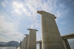 Bridge is under construction on the river in China.