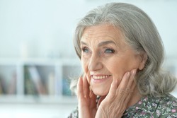 Close up portrait of senior woman at home