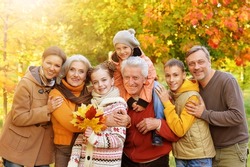 Portrait of a large family of seven different generations in autumn