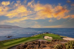 oceanside golf course with bunker,  ocean and clouds