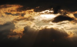 Sun rays shining through the storm cloud