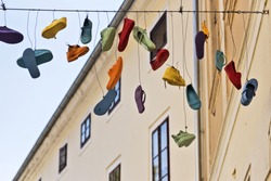 Various shoes hanging from a cable in Varazdin, Croatia