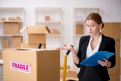 Young female professional mover doing home relocation