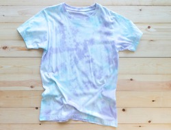 Colorful tie die tshirt on wooden background. asian fashion summer