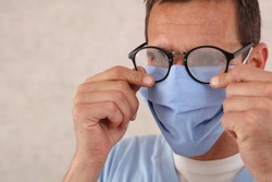Medical mask and Glasses fogging. Coronavirus prevention, Protection. Male doctor portrait close up