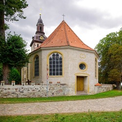 The Baroque village church of St. Andreas in Nehringen, community of Grammendorf, Mecklenburg-Western Pomerania, Germany: Choir and apse as well as cemetery wall with keyhole embrasures.