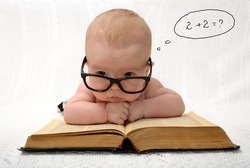 portrait of adorable baby in glasses counting in mind with handwritten thought tag with case study