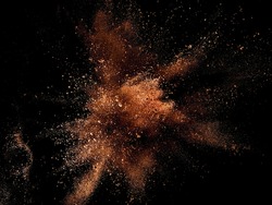 Cocoa powder mixed with few of dry milk explosion on black background