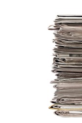 Cropped image of a pile of old newspaper displayed on white background for recycling.