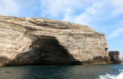 cliffed coast and a big Cave like hat of Napoleon near Bonifacio Town in Corsica France seen from the Mediterranean sea