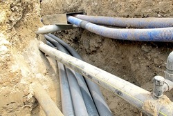 electrical cables and optical fibres in the digging on a construction site