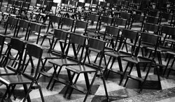 empty chairs without people in the church a symptom of a profound religious crisis that distances the faithful from places of worship in black and white effect