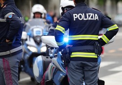Italian Policeman with the uniform with the text POLIZIA which means Police and the motorbike with the siren turned on during the raid to fight organized crime NOT USABLE FOR ADVERTISING PURPOSES