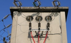 detail of the high voltage electrical cables in the substation with insulators and powerlines
