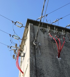 detail of the high voltage electrical cables in the substation and powerlines in tension