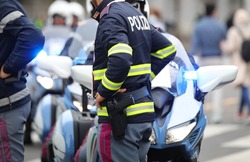 policeman with the text POLIZIA which means Police in Italian language and the motorbike during a search of the police in Italy