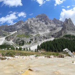 torrent that flows from the foothills of the Dolomites mountain mountains in northern Italy in summer