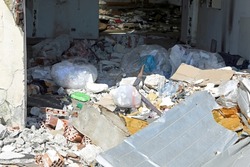 pile of debris of an abandoned building with many garbage