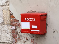 old red mailbox with the words POLISH POSTAL service