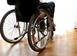 person with disability in the bedroom with parquet floor