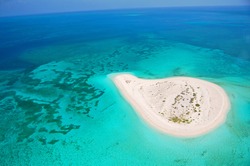 beautiful deserted island in coral reef ocean