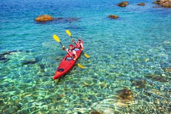 Couple men floating on a sea kayaking. Traveling by kayak outdoors on a summer day.