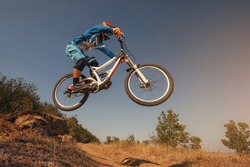 Mountain Bike cyclist jumping. Downhill biking. Extreme sports cycling.