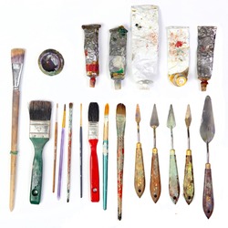 professional brushes with a palette knife and tubes of paint isolated on a white background