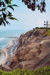 La Marina Lighthouse on a hill in the Miraflores area of Lima, Peru. Cityscape with ocean.