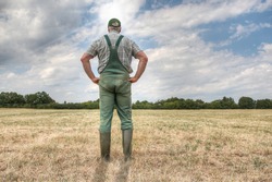 A farmer stands on his parched meadow and hopes for rain while the sun shines mercilessly on his farmland. Rising temperatures and too little rain the arable land in Germany is dry like never before.