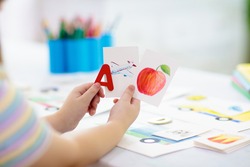 Kids learn to read. Colorful abc phonics flash cards for kindergarten and preschool children. Remote learning and homeschooling for young kid. Child reading sounds and letters. English lesson.