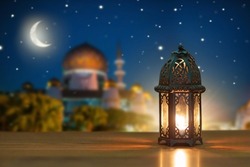 Ramadan Kareem greeting. Islamic lantern on night sky with crescent moon and stars. End of fasting. Hari Raya card. Eid al-Fitr decoration. Breaking of holy fast day. Muslim holiday.