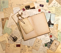 old letters, french post cards and empty open book. nostalgic vintage background