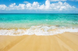 Sand beach, blue sea and cloudy sky. Summer travel background