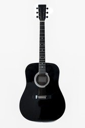 A black acoustic guitar isolated on a white background