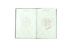 Open german passport  to two pages with some customs stamps on a white background