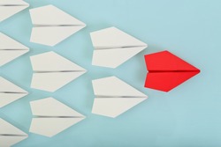 red paper plane leading white ones, leadership concept