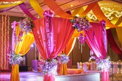 The colorful stage decoration with bright shade of color for bride and groom in the sangeet night of traditional indian wedding