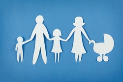 Closeup of happy paper family on blue background