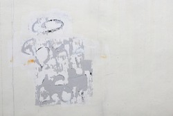 White Dirty wall with Scratched advertising, Torn Posters, Stickers or Graffiti.
