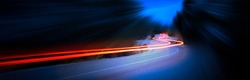 Cars light trails at night in a curve asphalt, mountains road at night, long exposure image, panorama