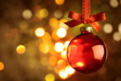 Christmas red bauble and bow  over magic bokeh  background 